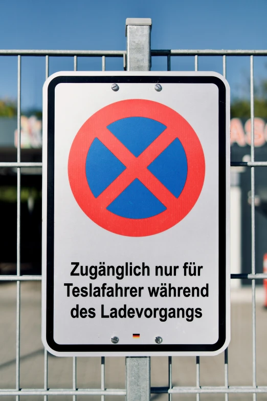 sign attached to fence indicating the direction of parking