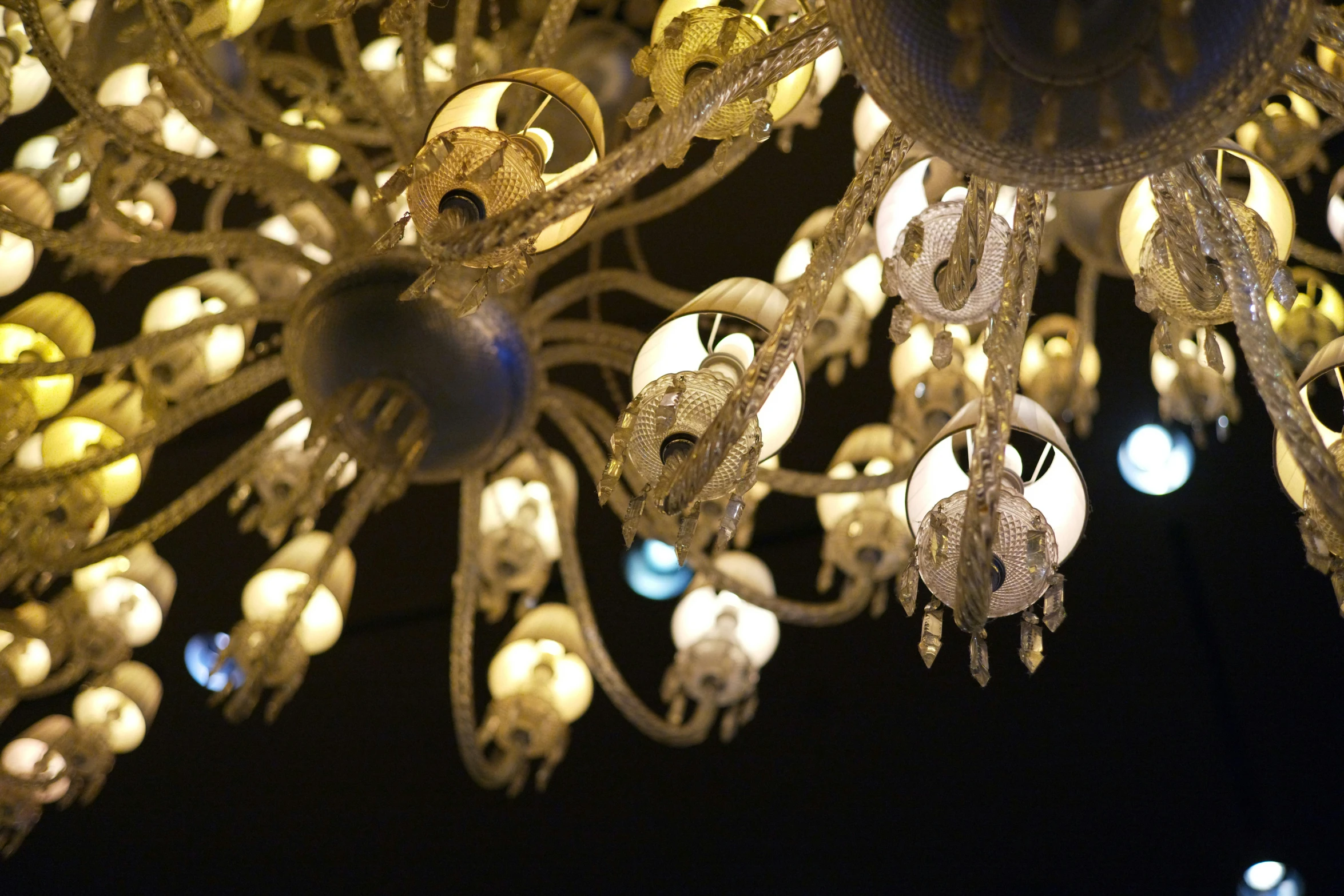 an elaborate lighting fixture with ornate details on a ceiling