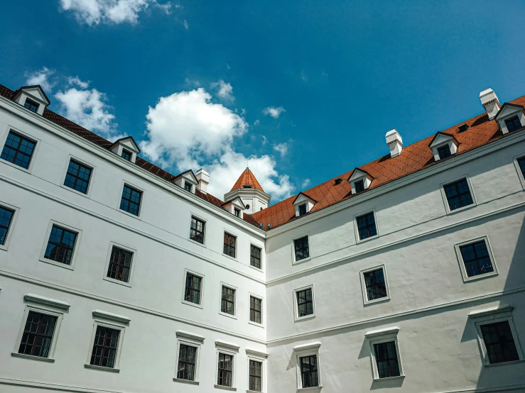 an orange roof line the exterior of a building