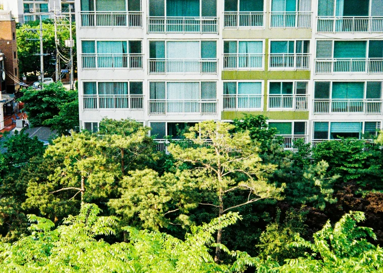 large apartment building with multiple balconies in foreground