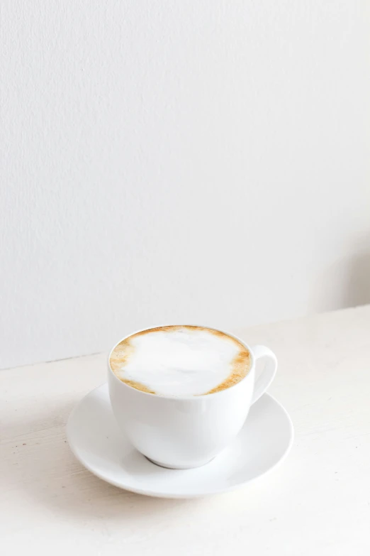 coffee latte sitting on a white saucer