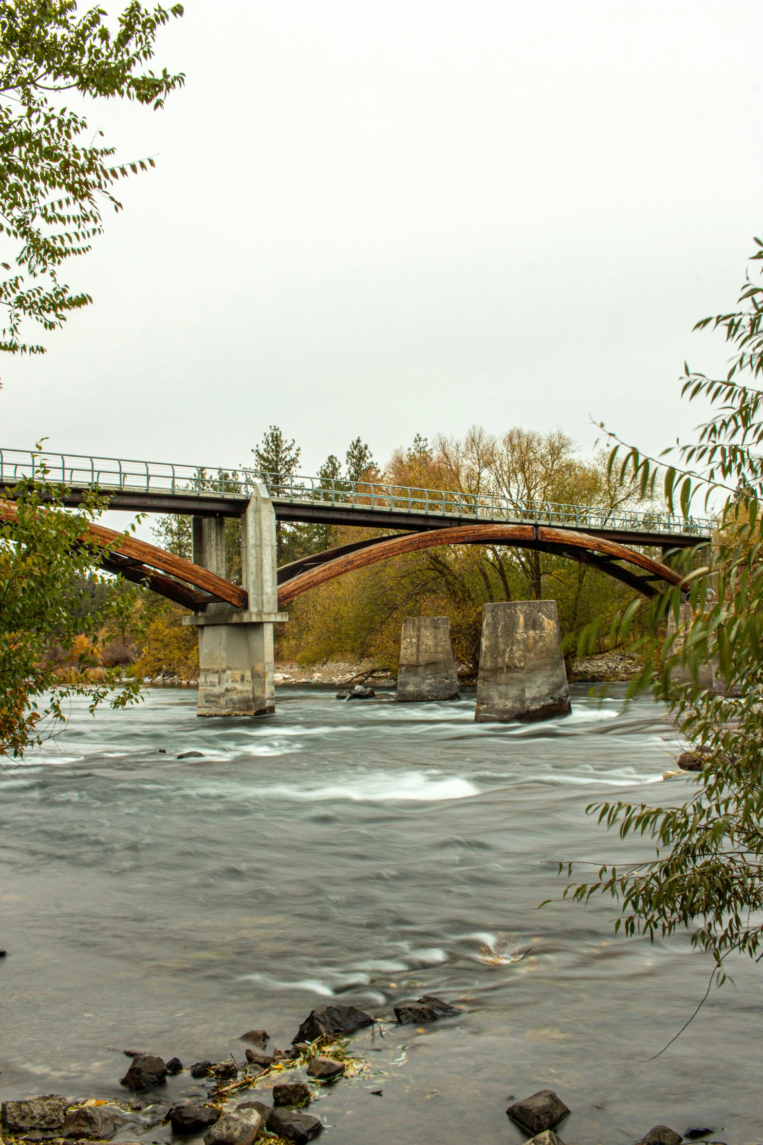 a large river flows under a bridge with water