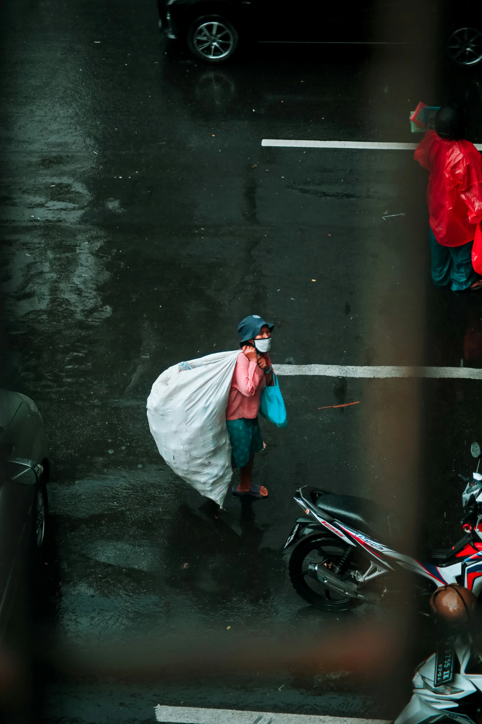 a man carrying bags and standing on a street