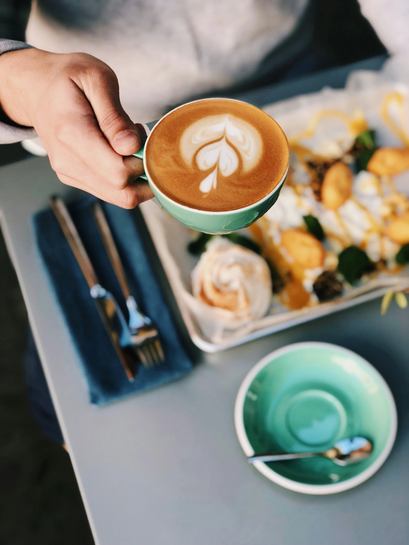 a cup with the name latte on it is being filled with coffee