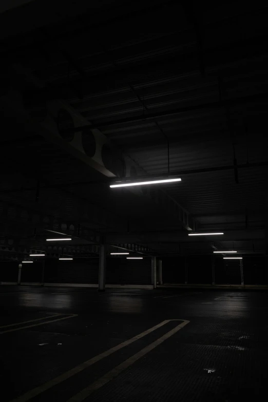 an empty parking lot with lights from underneath