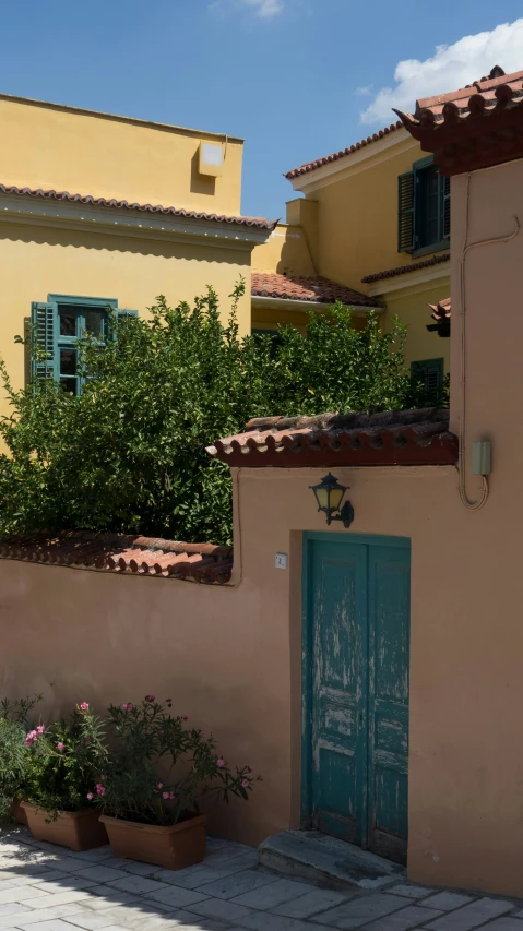 a very pretty pink house with a blue door