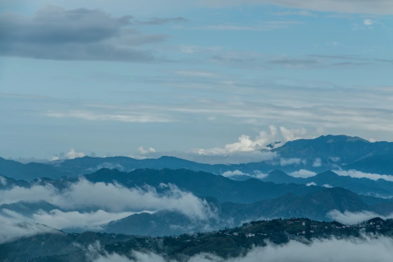 mountain range with low lying clouds moving in front