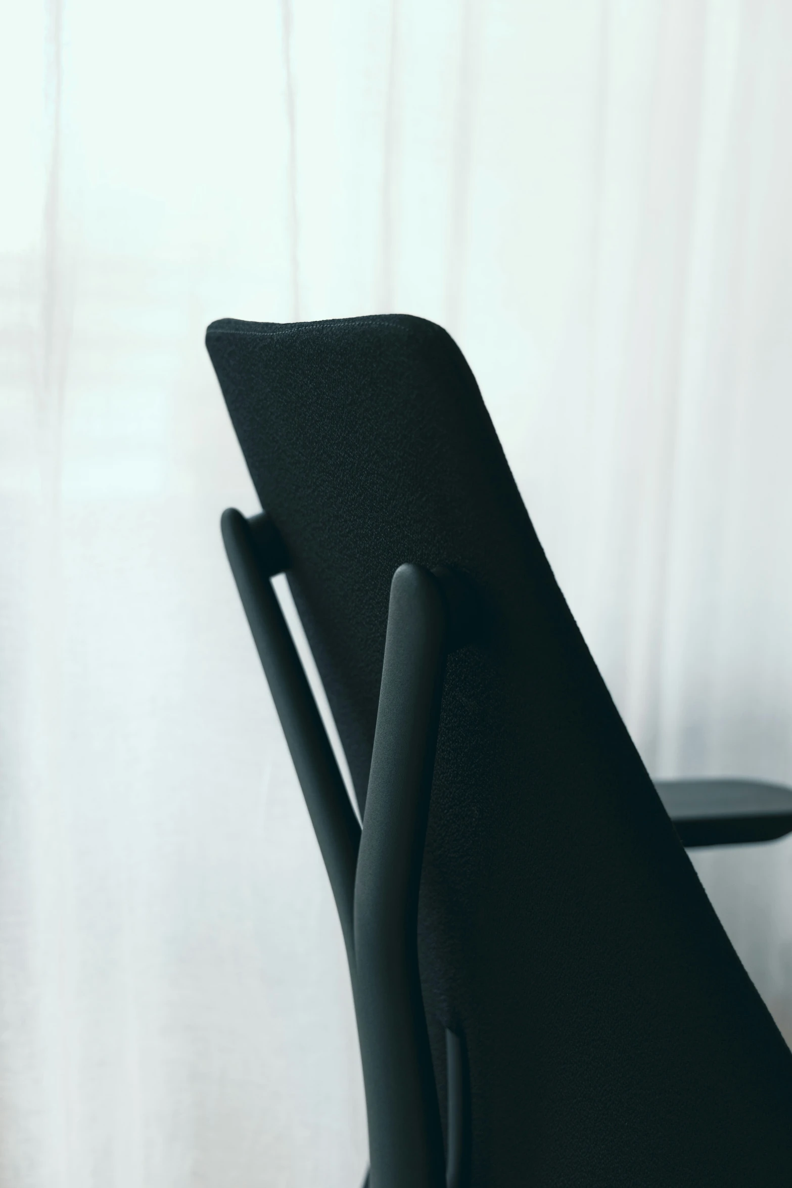 a black chair in front of a window