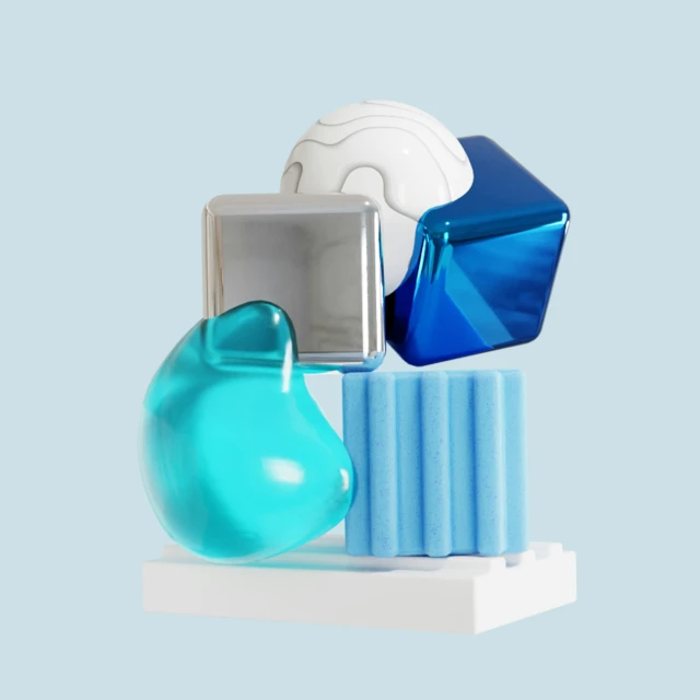 three blue glass objects displayed together on a pedestal