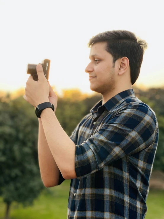 a man holding up a smart phone looking back
