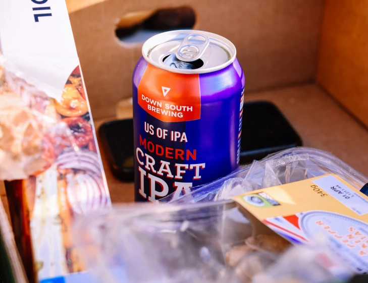 a can of beer on top of a plastic container