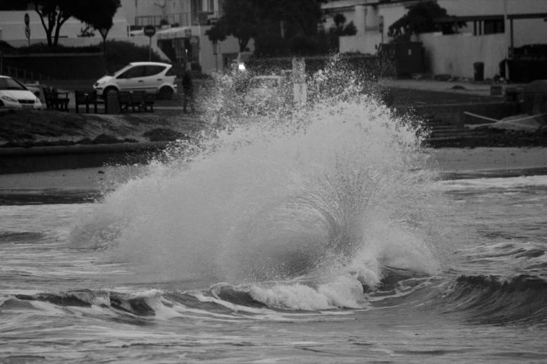 a black and white po of an ocean spray on a street