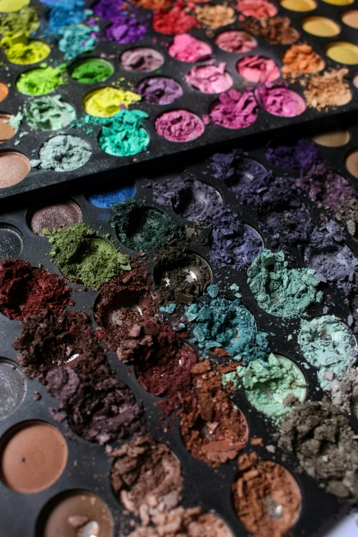 colorful makeup palettes are laid out on a table