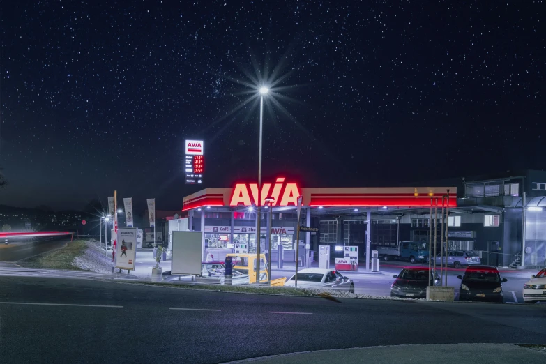 the street is very busy in front of a gas station