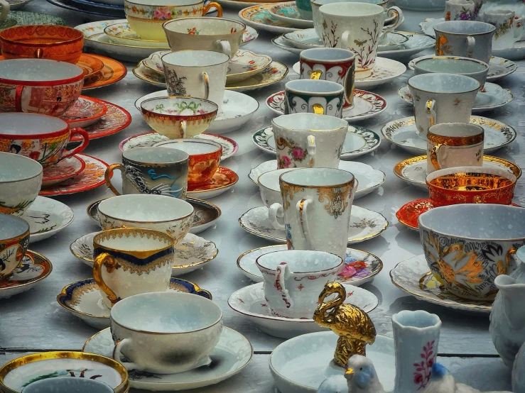 a large table filled with lots of dishes and cups