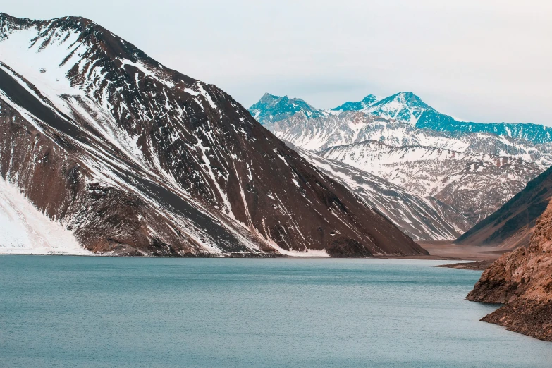 a mountain area covered with snow and some mountains