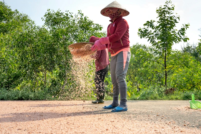 two women in boots and hats in the dirt