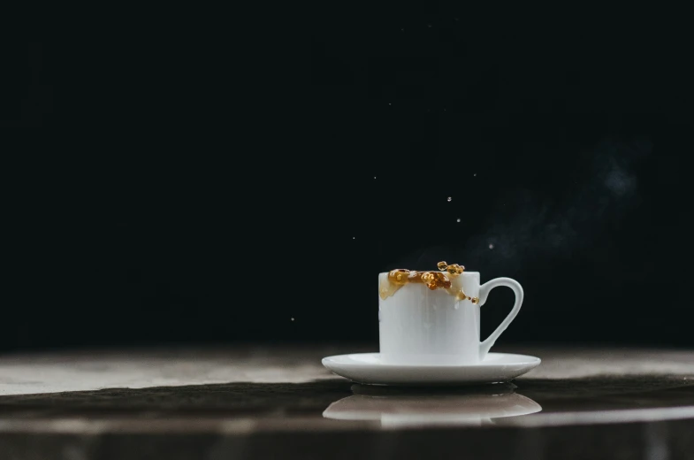 a coffee cup with food on it and smoke coming from its bottom