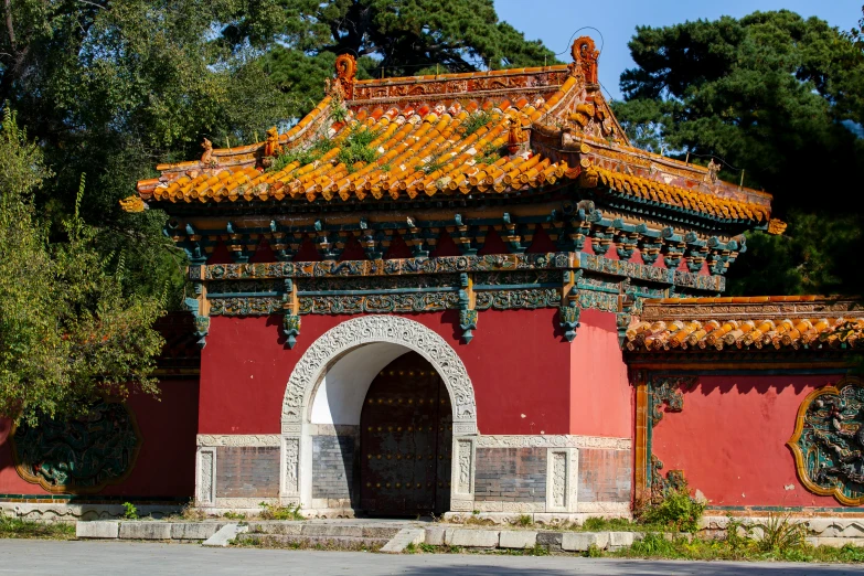 a red building is decorated with an archway