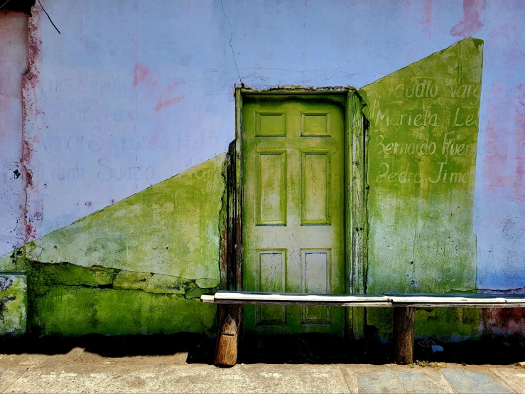 an open door and bench in front of the house