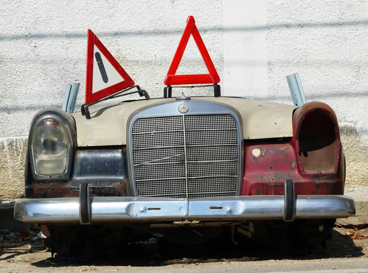 a car with a warning sign on the hood of it