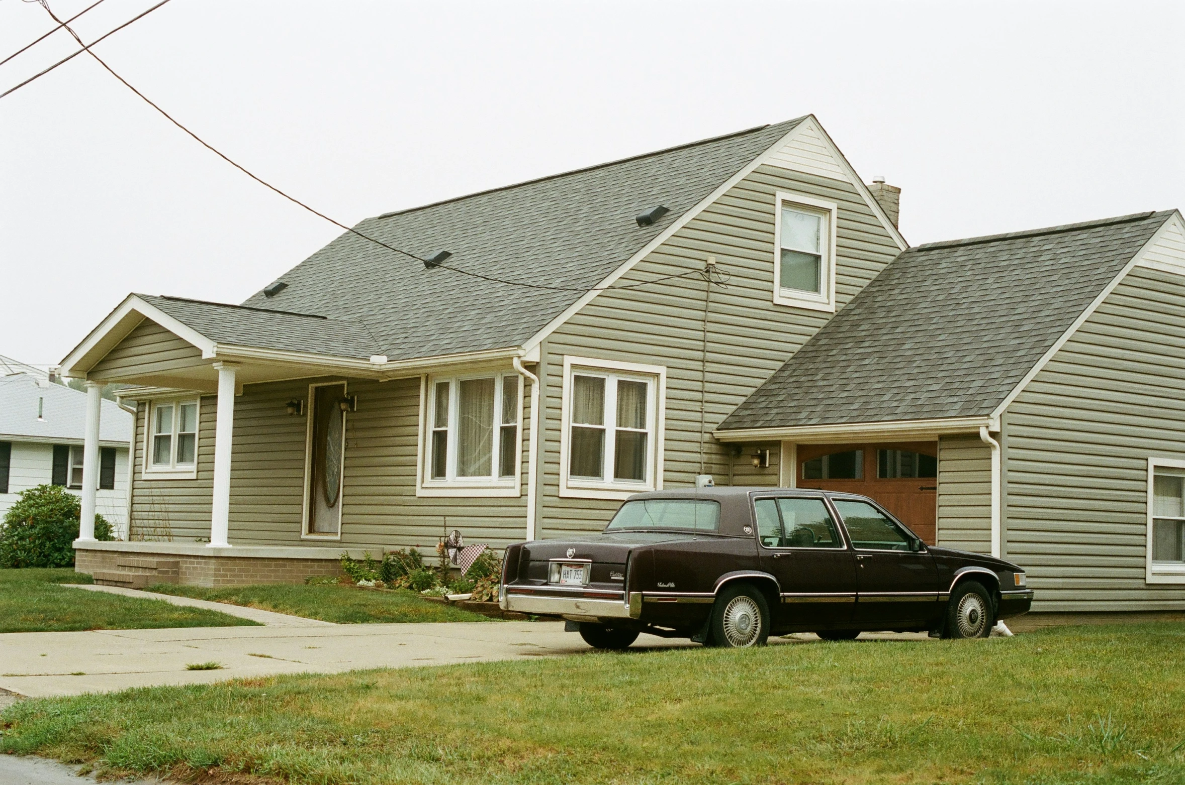 a brown pick up truck parked in front of a house