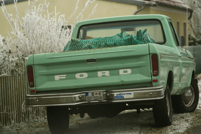 a large green truck parked in front of a building