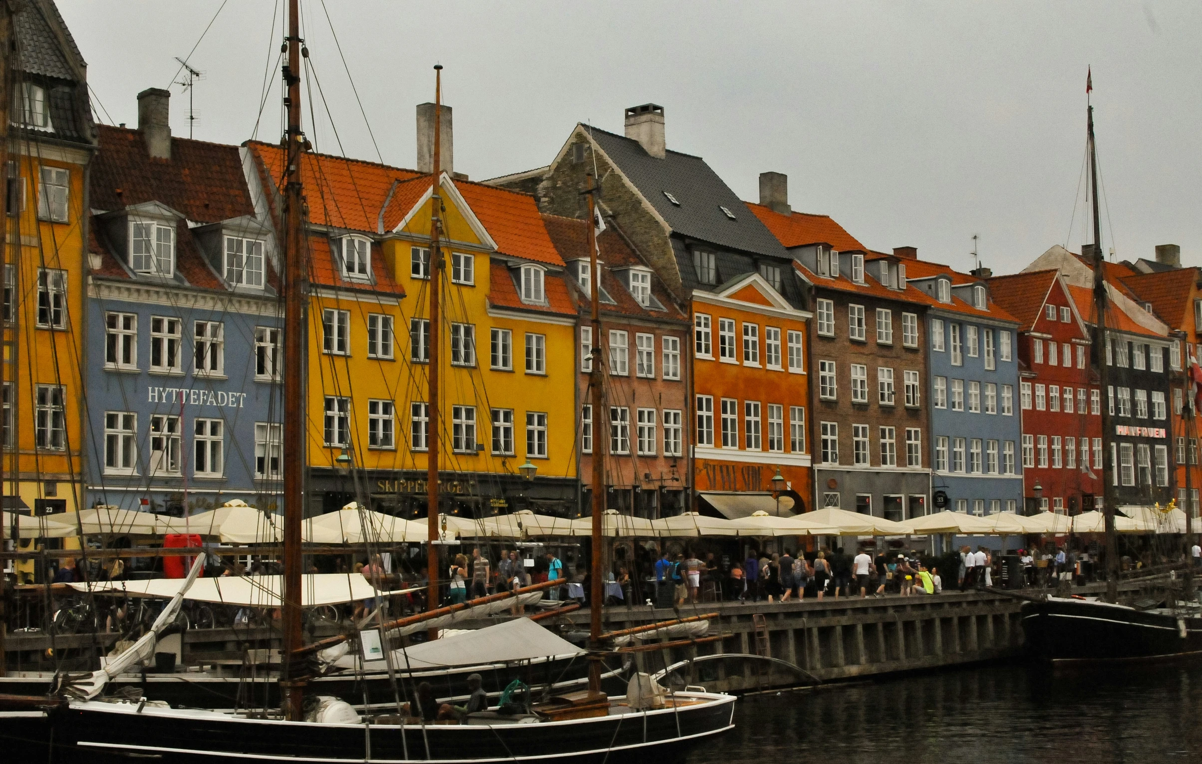 several buildings next to water with boats parked