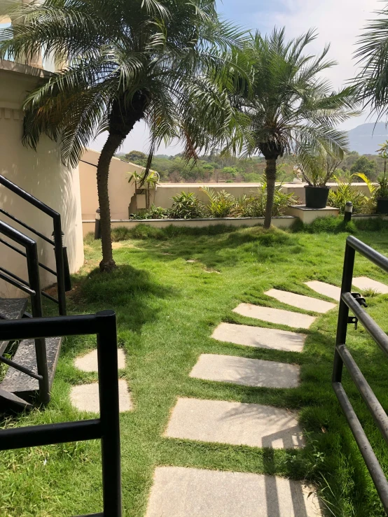 stairs lead to the backyard where grass grows