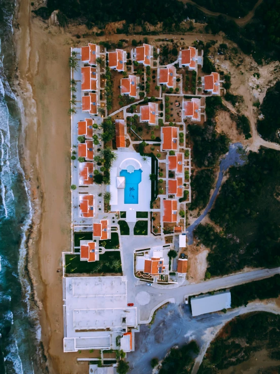 a aerial view shows the red houses and blue swimming pool