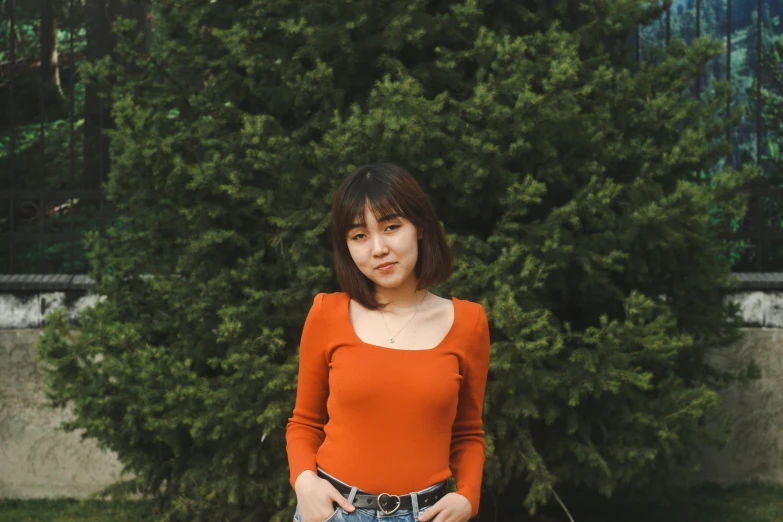 a beautiful young lady wearing a red shirt posing for a po