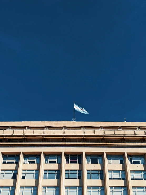 the building has windows on both sides and a flag flying in front