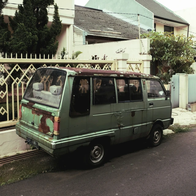 an old van parked in front of a building