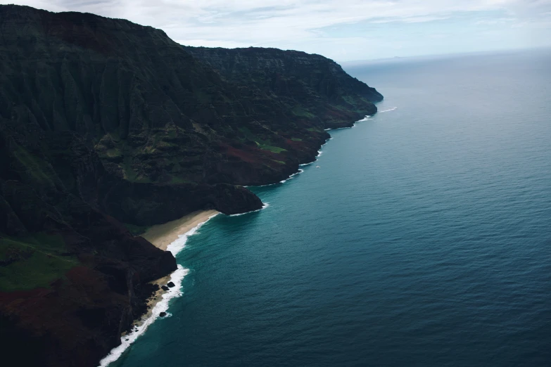 a view from a plane looking down on the water and cliffs