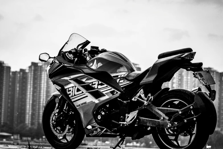 a motorcycle is parked next to the cityscape