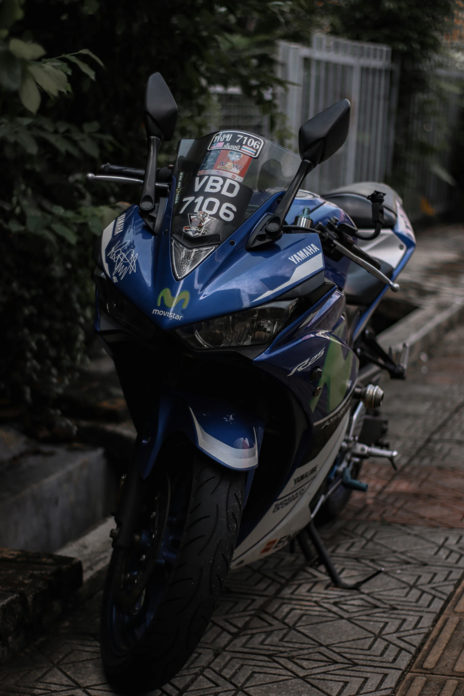 a blue motorcycle parked on the side of a street