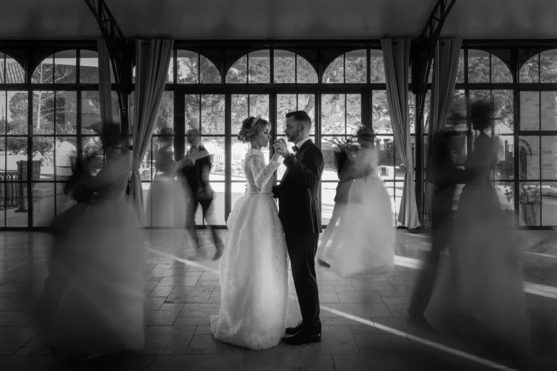 bride and groom stand on the steps of the church