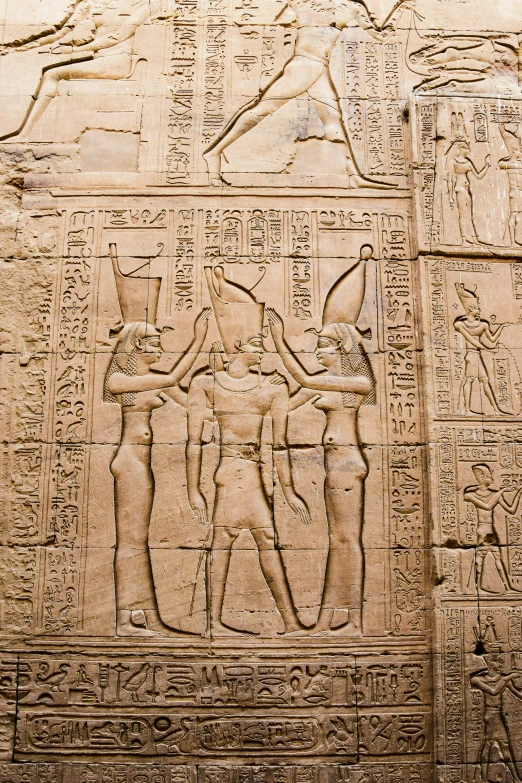 an ancient egyptian relief of gods and goddesss