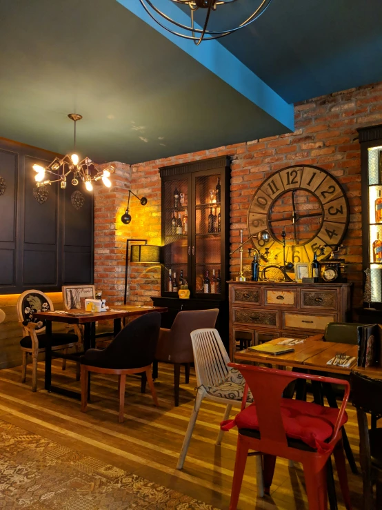 a wooden table in front of a big brick wall