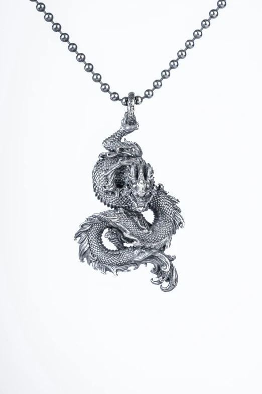 a dragon is depicted on a ball chain