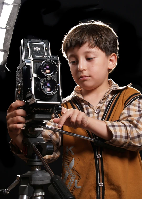 a boy using a video camera for a pograph