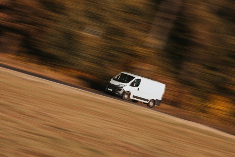 an delivery truck is driving on the side of the road