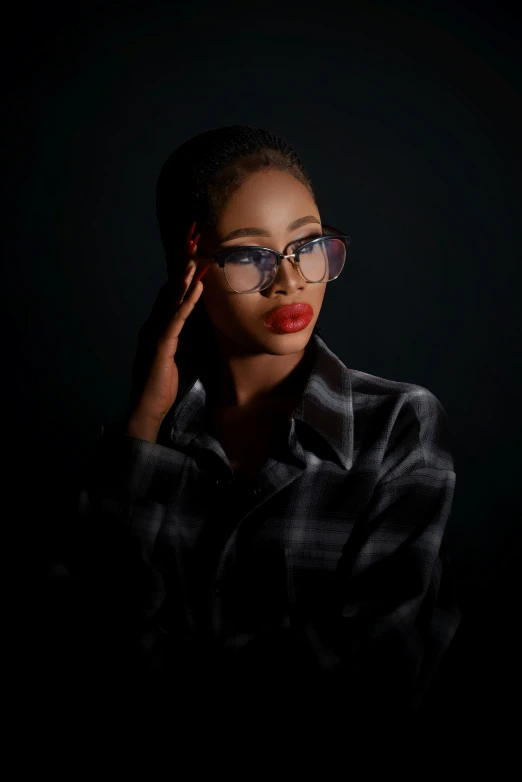 a black female with a red lip and glasses is posing for the camera