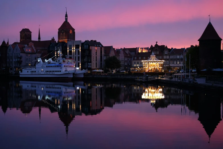 a river with a ship next to it and some buildings