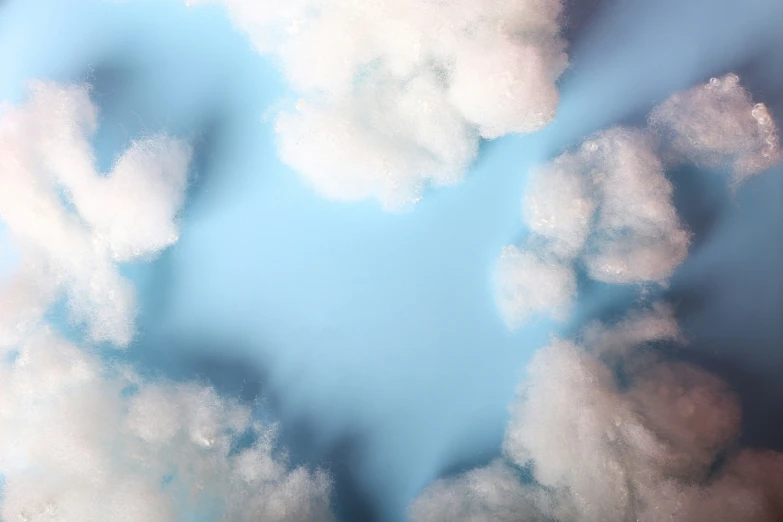 a po of white clouds with a blue background