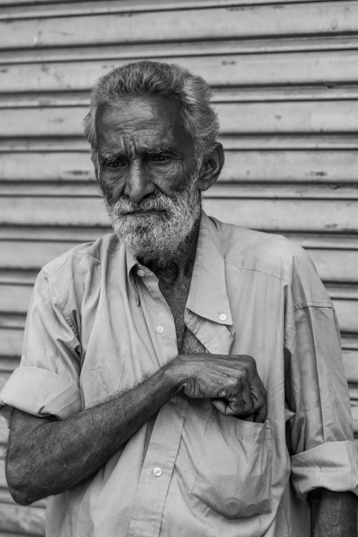 a man with graying hair and beard wearing a shirt