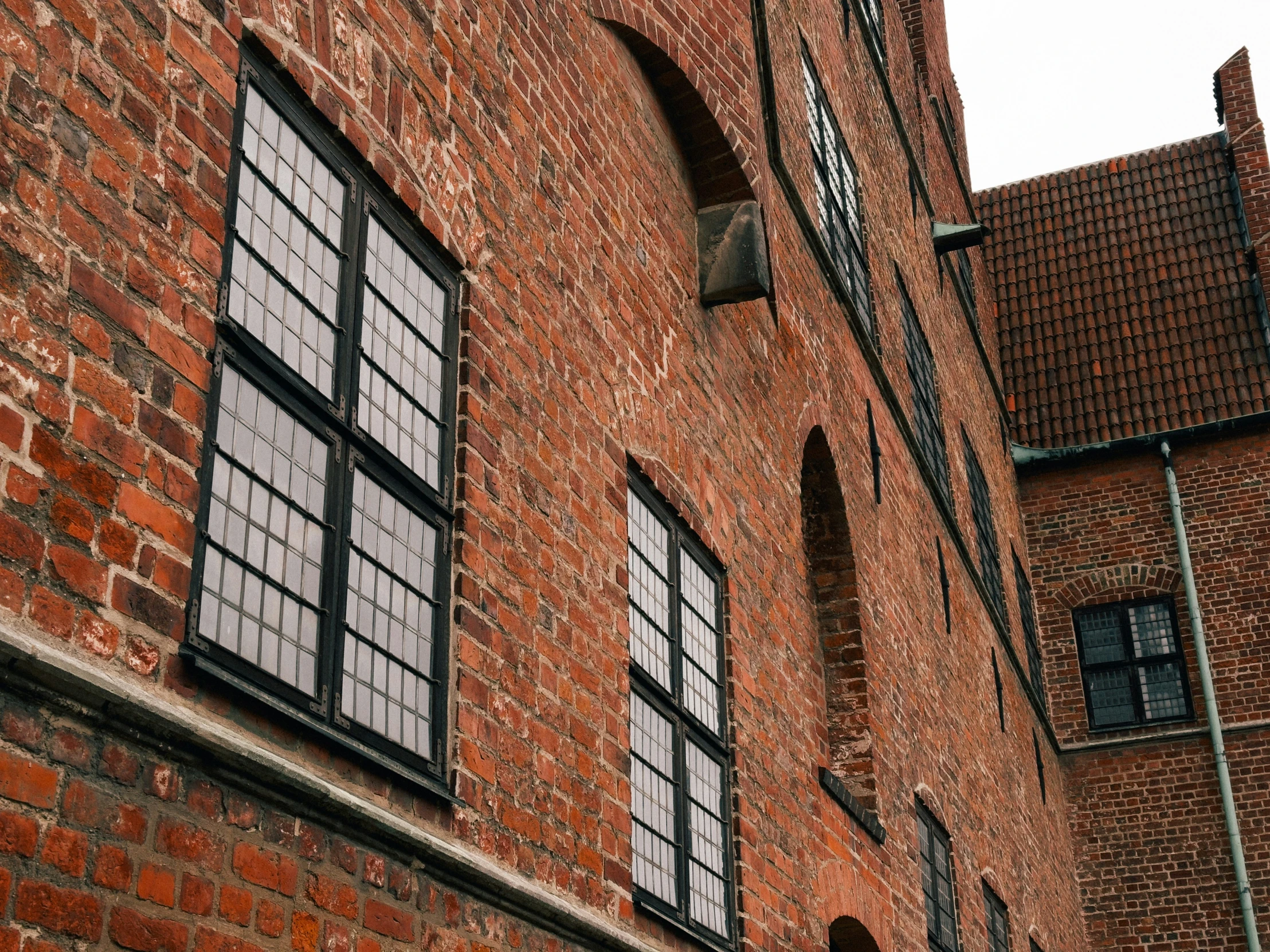 two large windows in an old red brick building