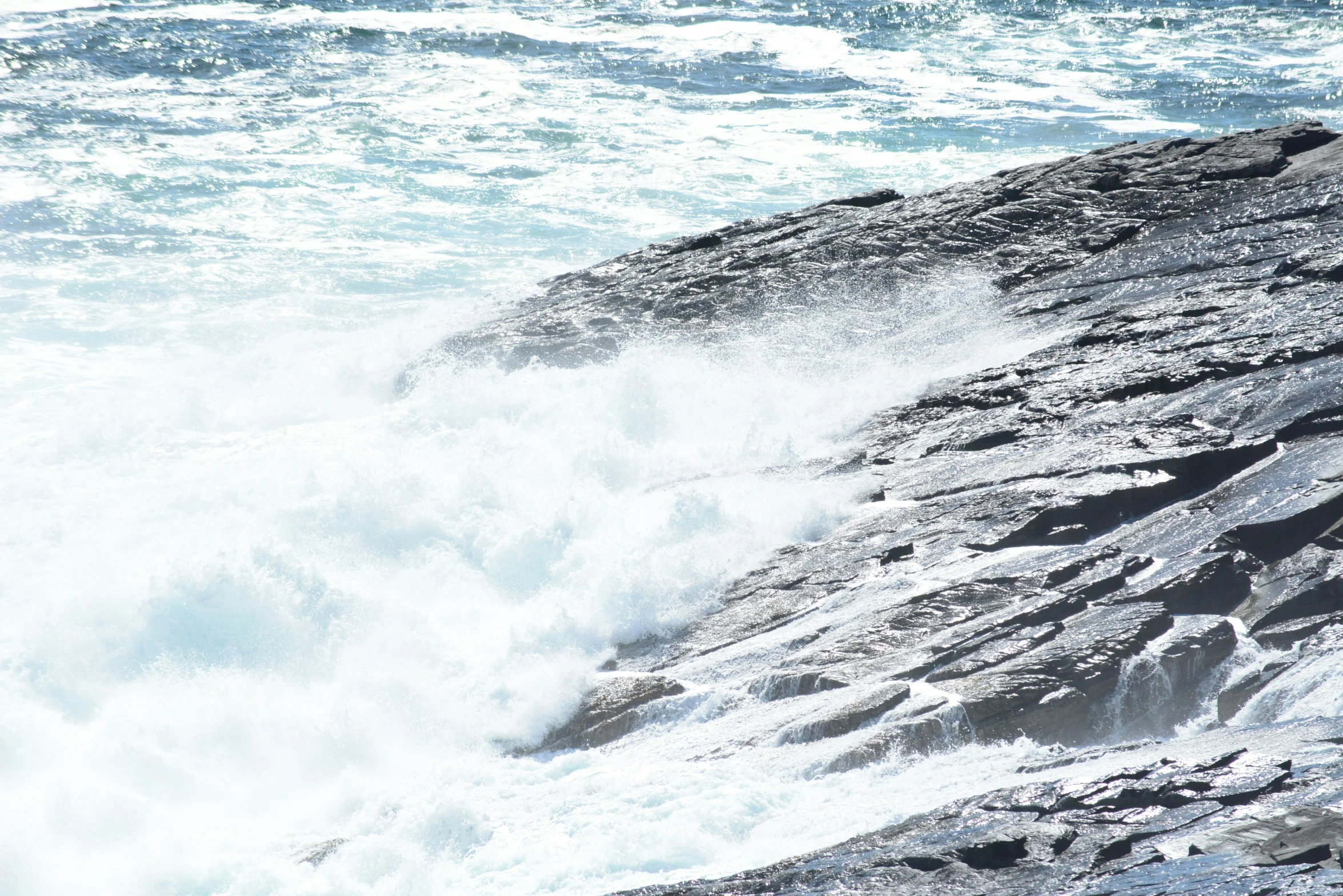 the wave is making its way across the rocks