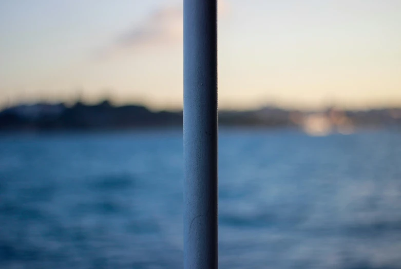 an empty sign stands against the edge of water