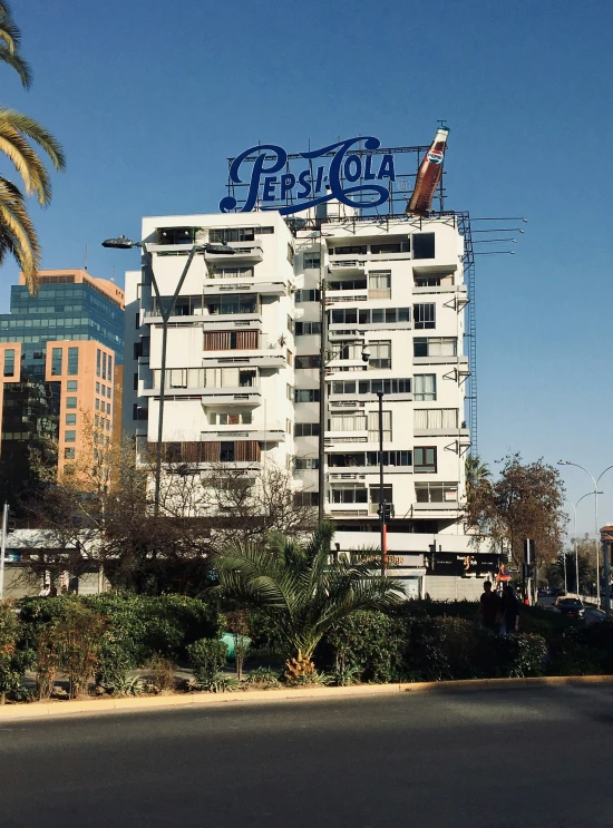 a white building with blue and grey lettering in the background